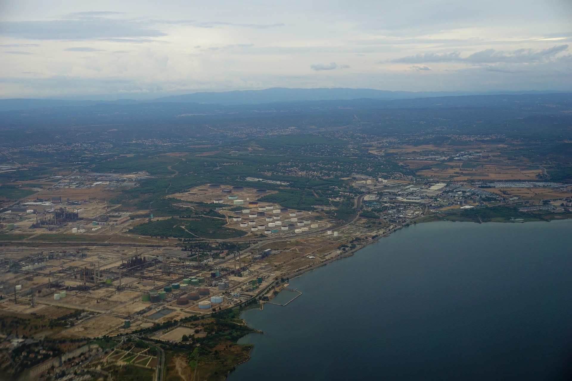 Aerial view of oil refinery on land near sea