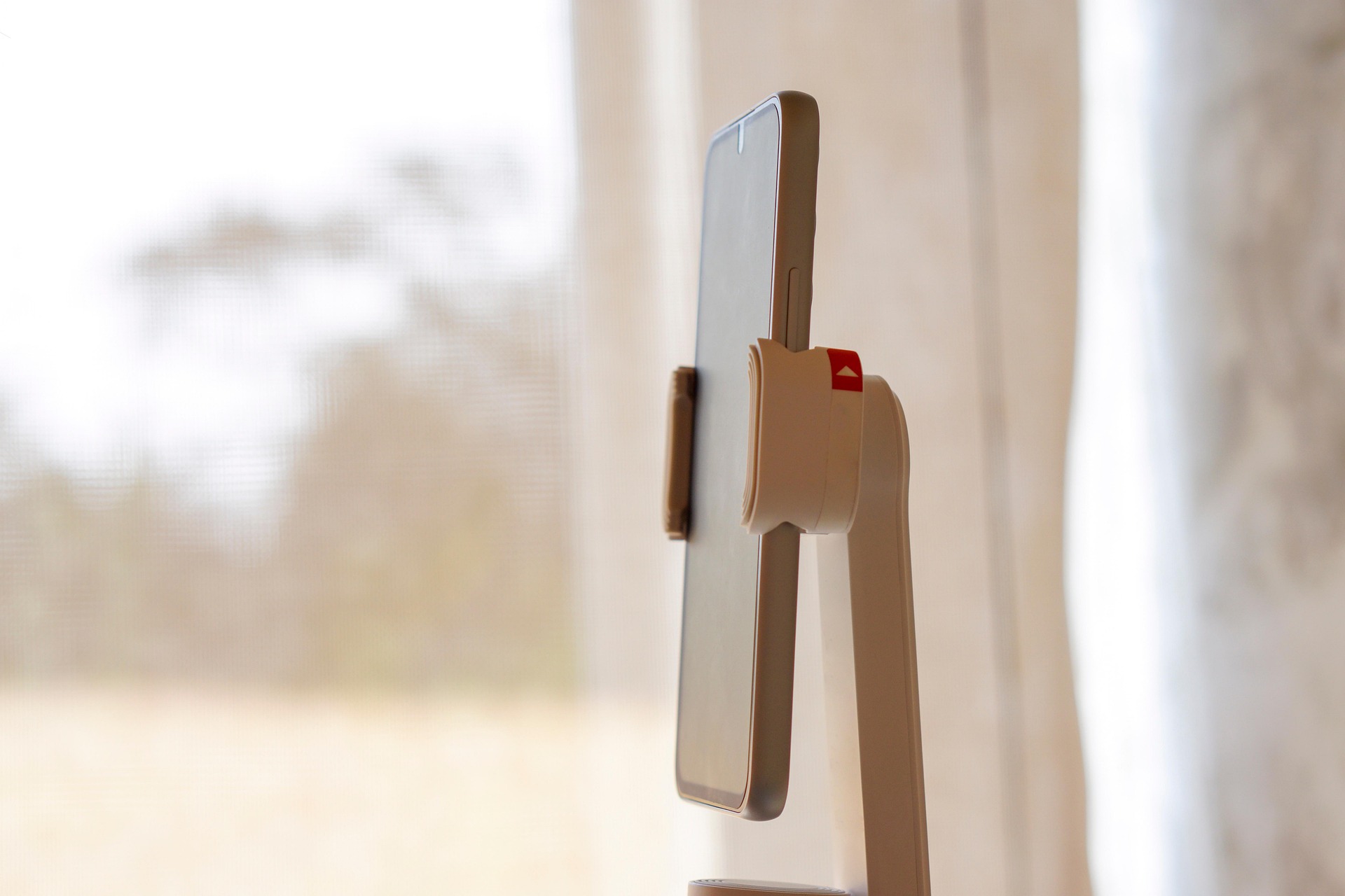 Ai smartphone held by white phone holder