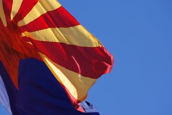Arizona US flag waving under blue skies