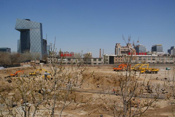 Construction in Beijing China with bare trees in forefront