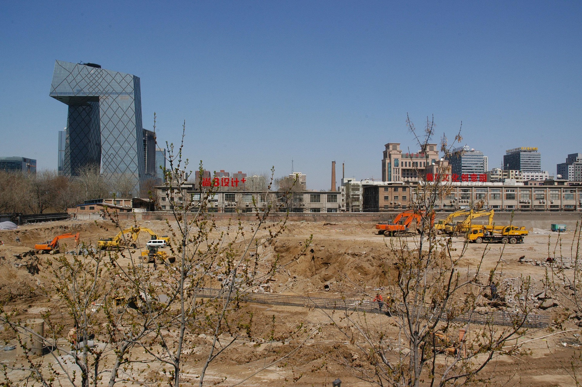 Construction in Beijing China with bare trees in forefront