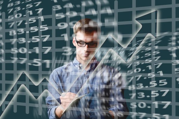 Depiction of stocks rising man on computer screen