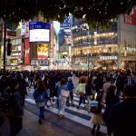 Japanese city many people walking through busy intersection at night