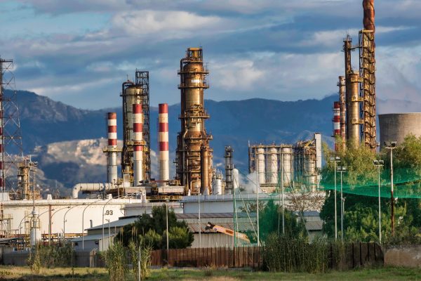 Oil refinery plant with mountains in distance