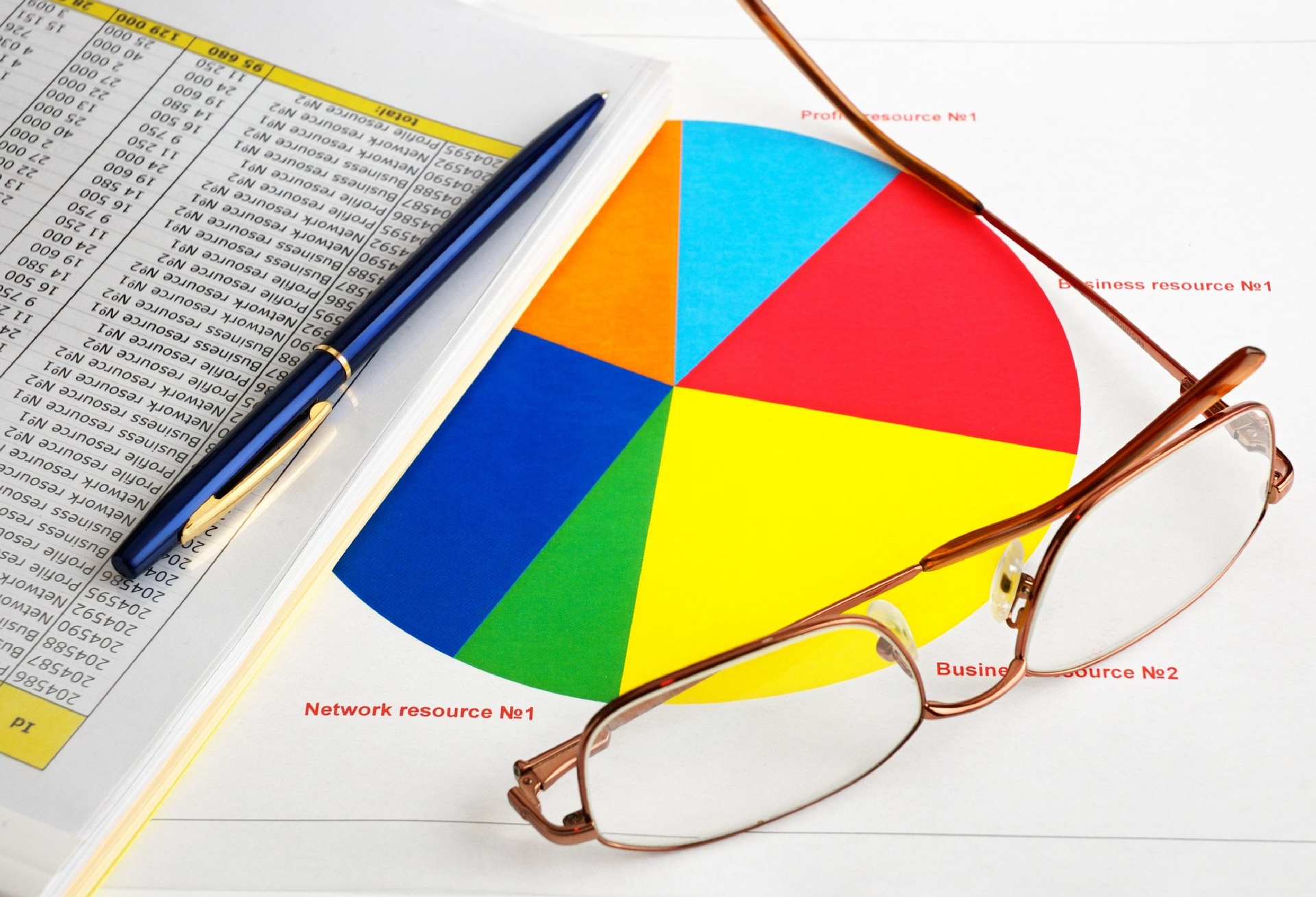 earning reports concept with glasses, data, and charts on table