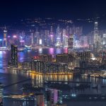 hong kong office buildings skyline in distance at night