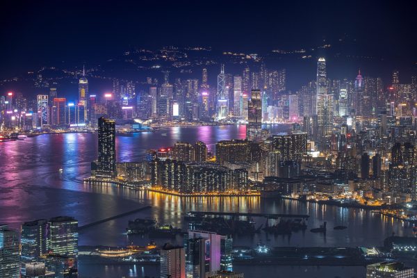 hong kong office buildings skyline in distance at night