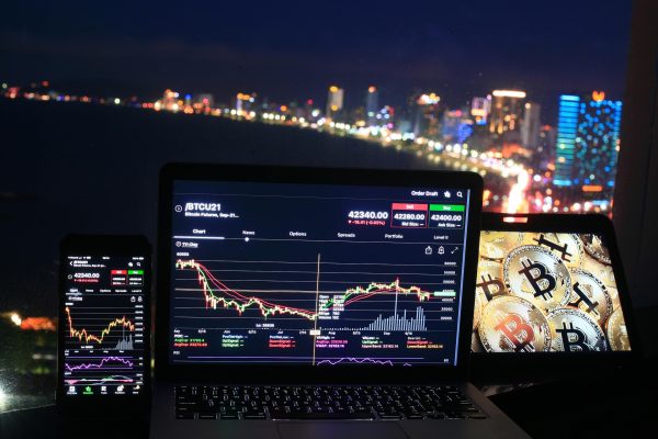 screens tracking stocks in front of window overlooking city skyline