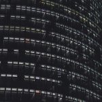 Circular office building at night with lights on