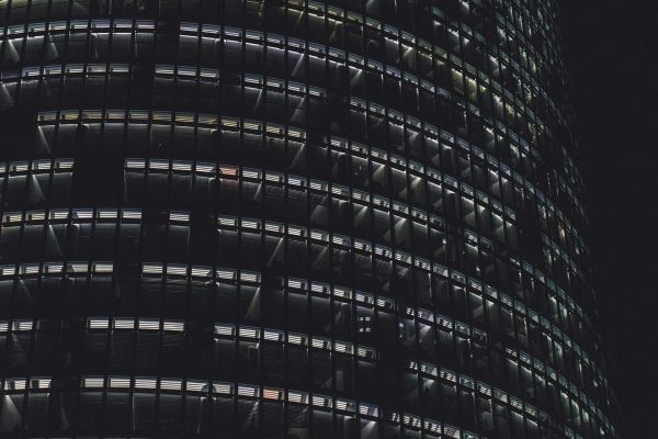 Circular office building at night with lights on