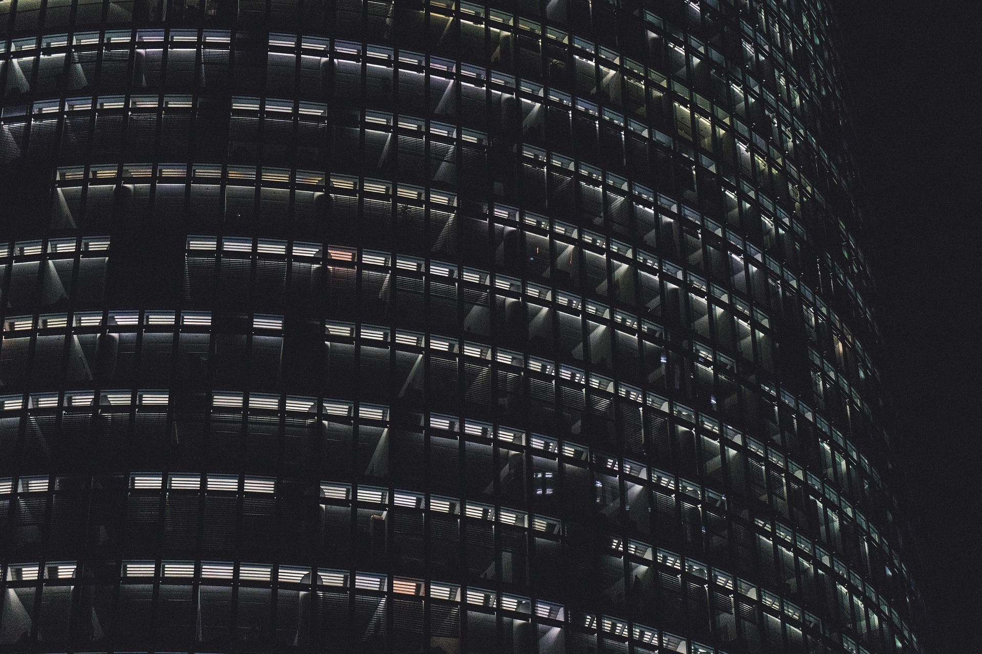 Circular office building at night with lights on