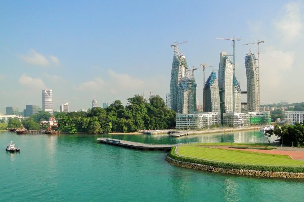 Singapore skyscrapers under construction with lake in foreground